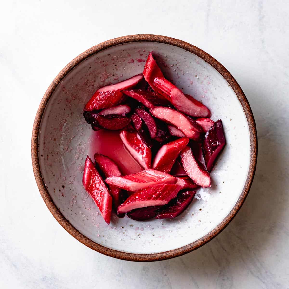 sliced rhubarb with sugar in a bowl