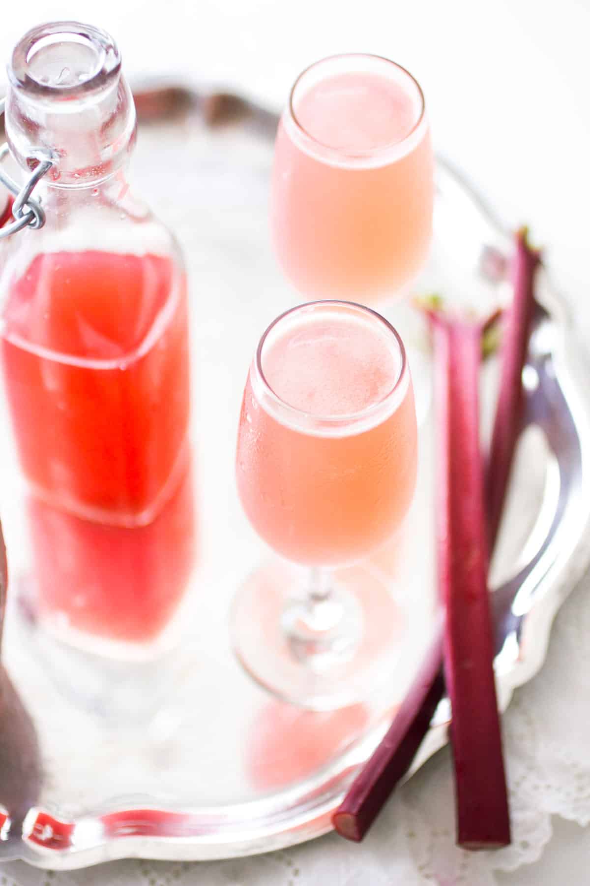 rhubarb cocktails and syrup on a silver tray