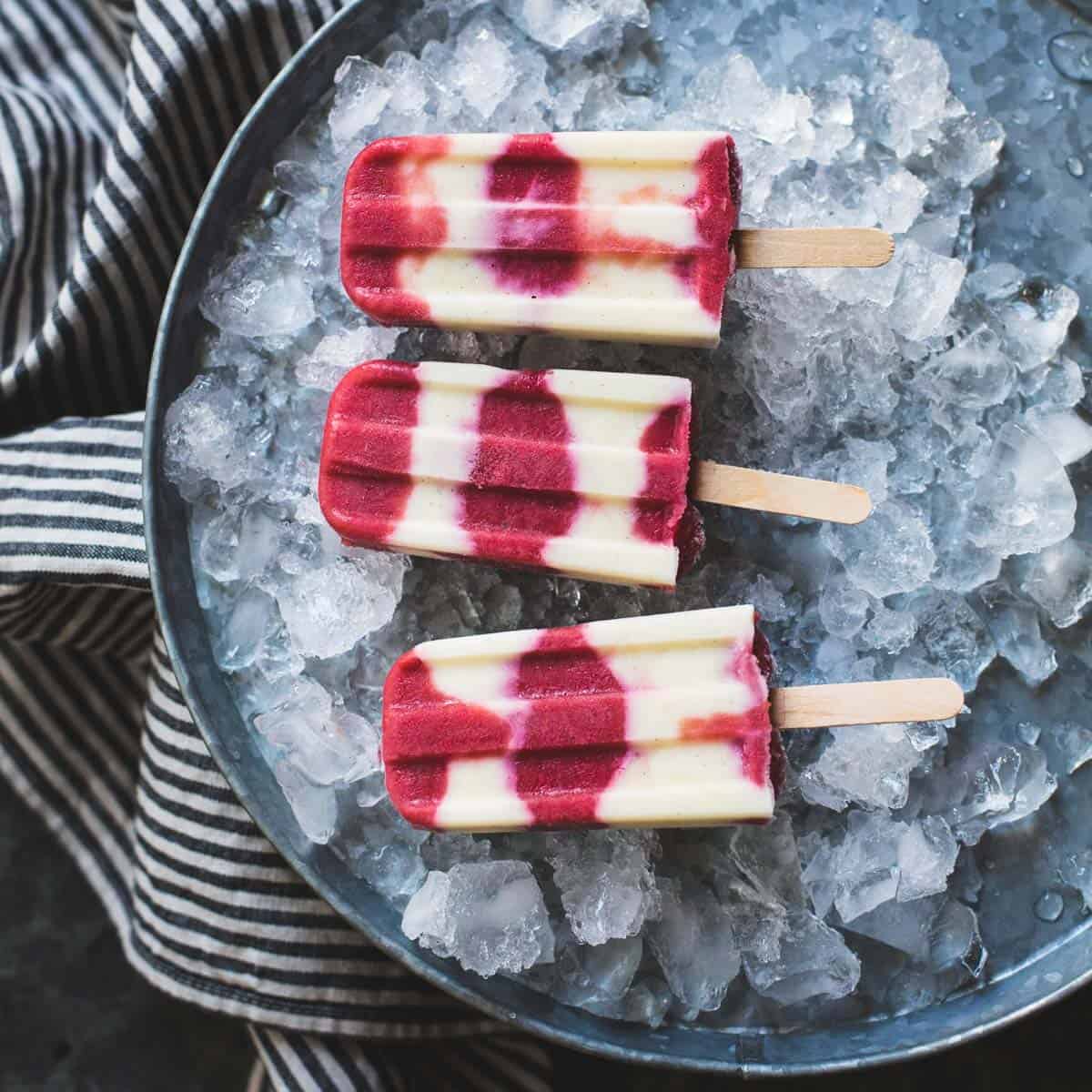 layered rhubarb yogurt popsicles on ice