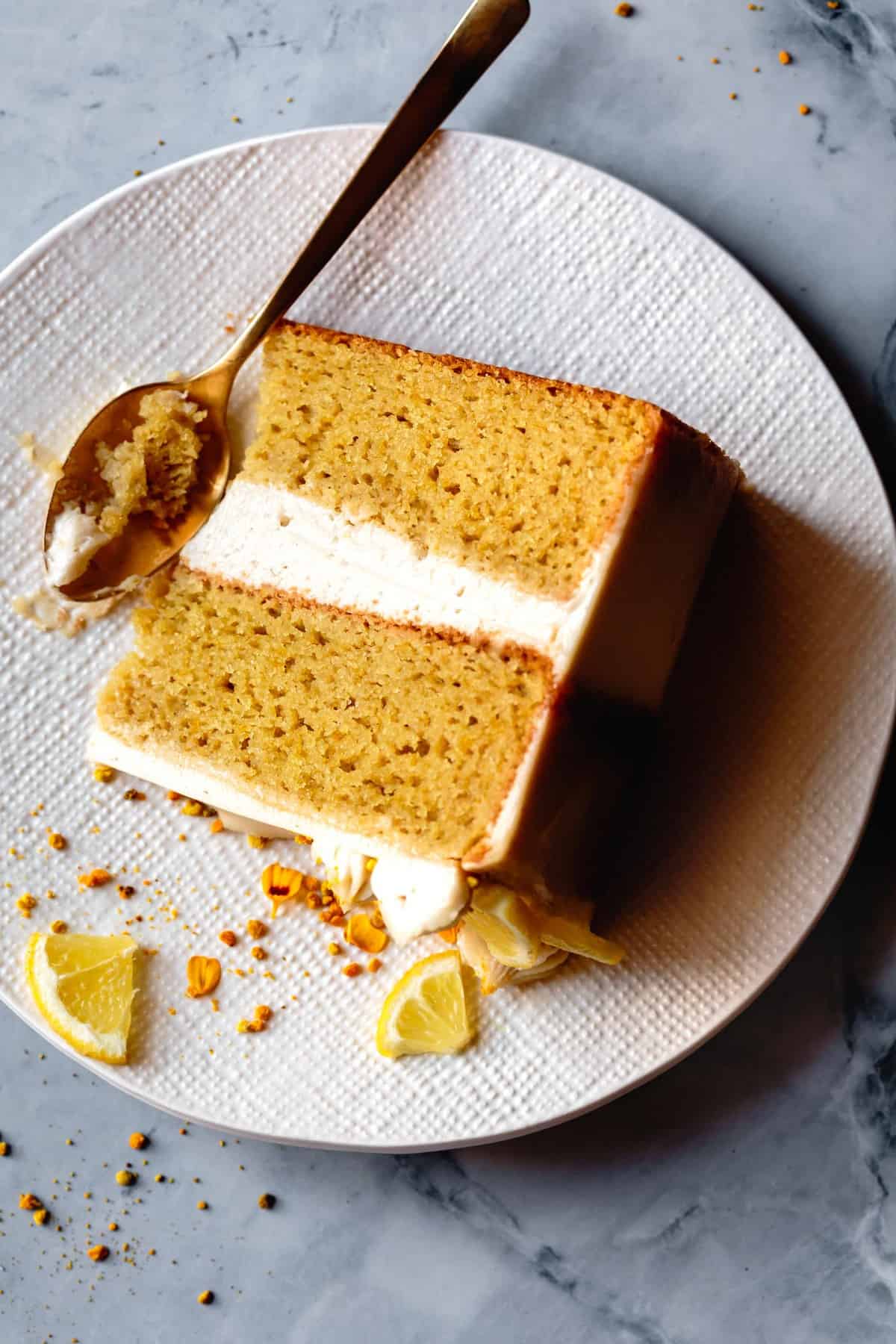 closeup of paleo lemon cake slice on a linen textured white plate