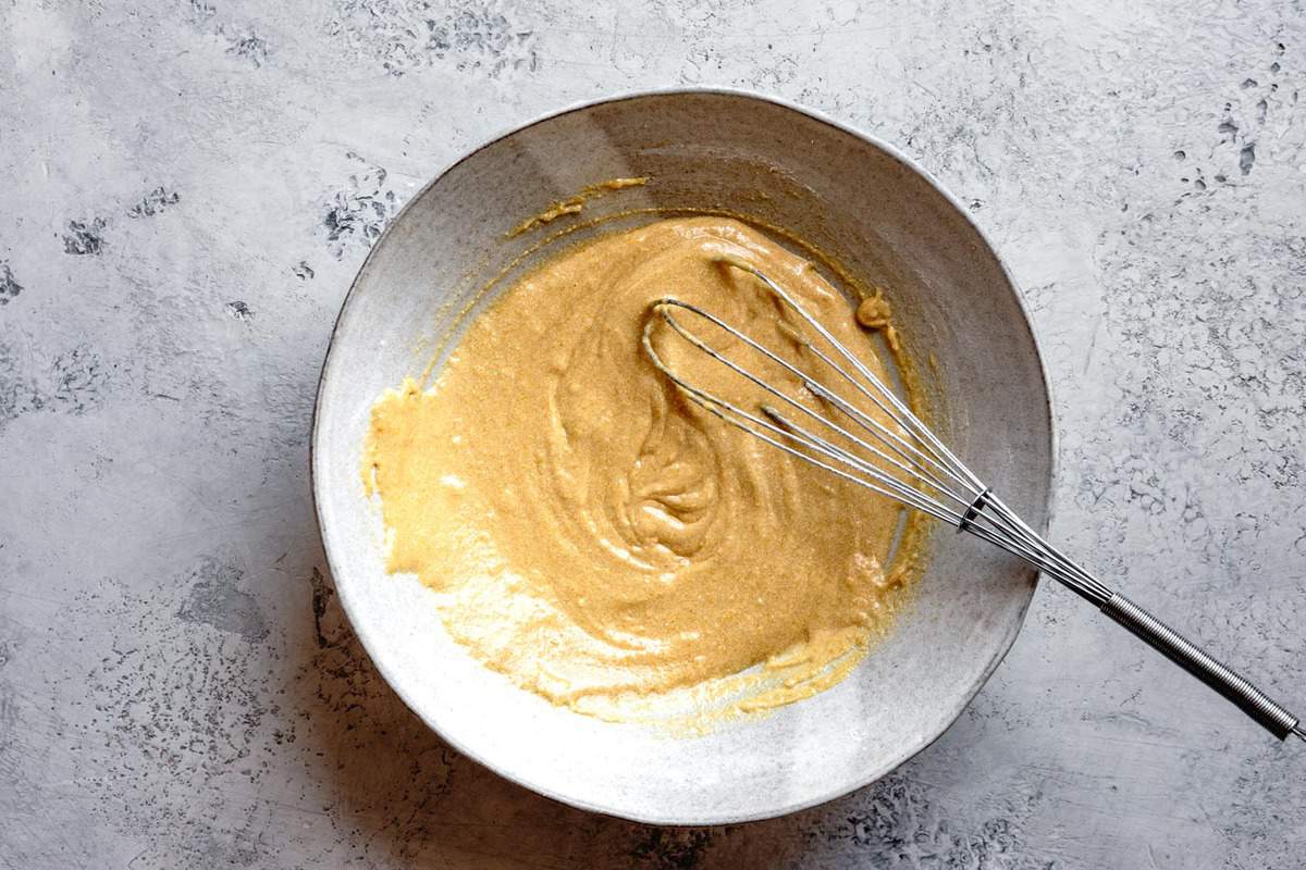 batter being whisked in a large stoneware bowl