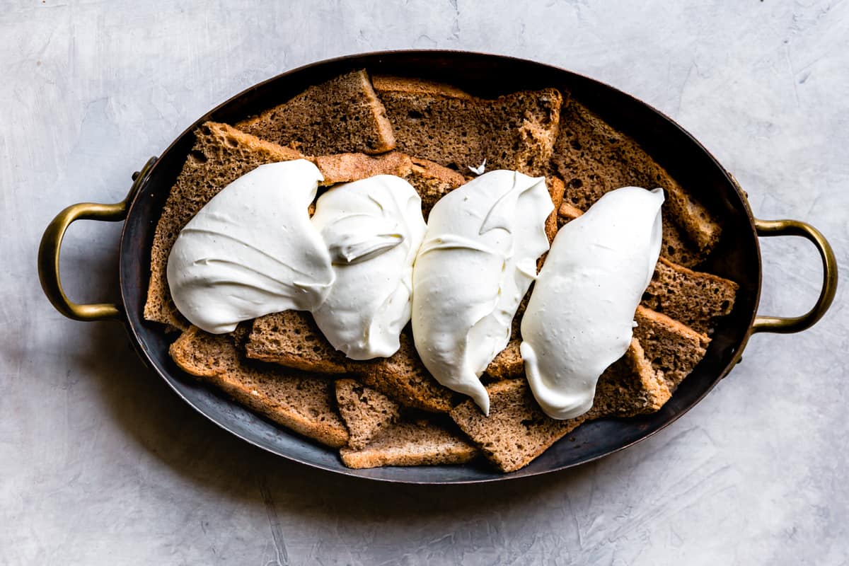 luscious dollops of cream over soaked cake slices