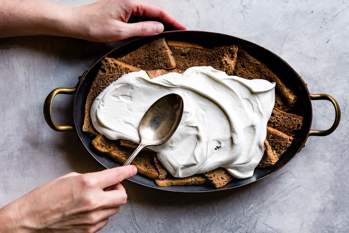 spreading mascarpone over cake slices