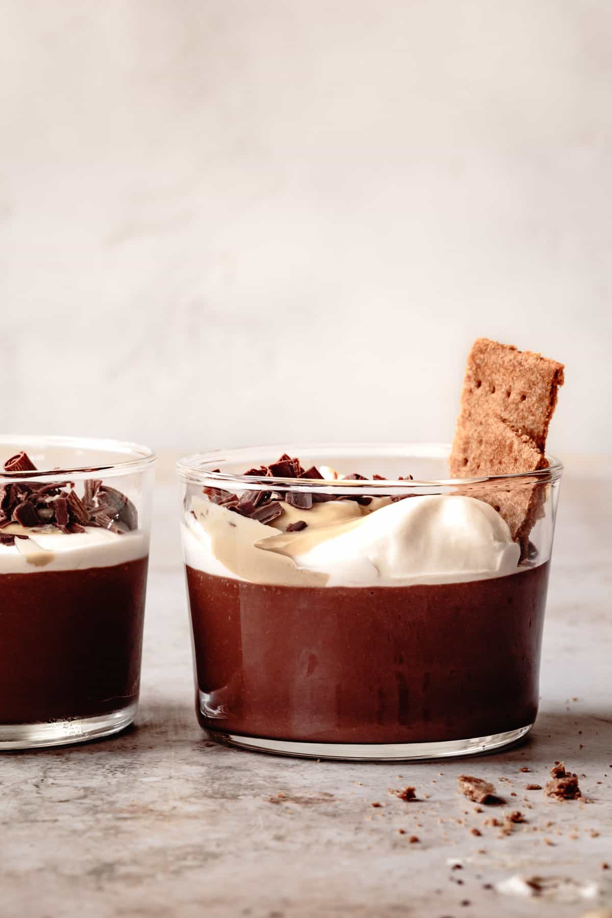 side view of healthy chocolate puddings + graham crackers