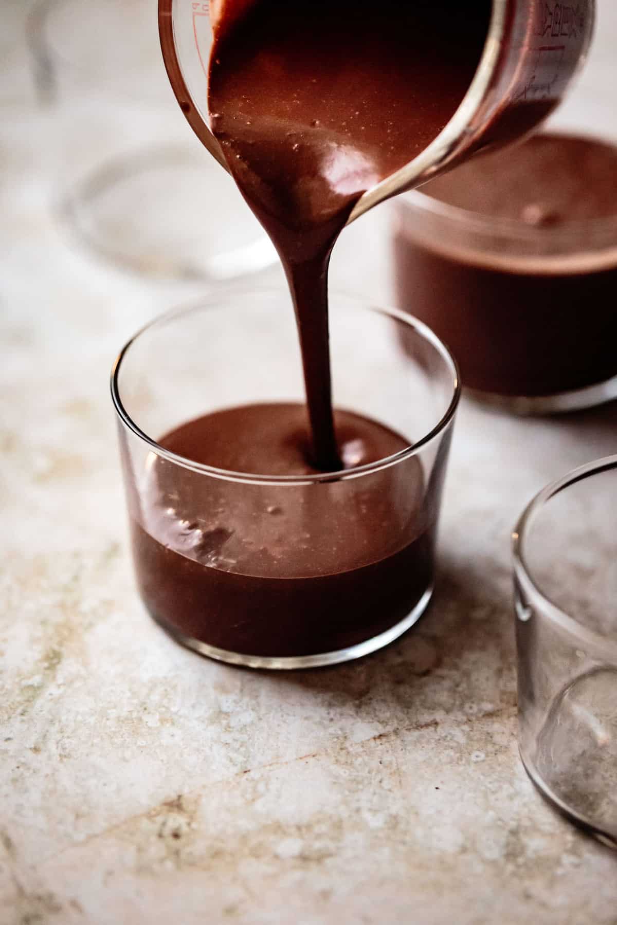 pouring liquid chocolate pudding into glasses
