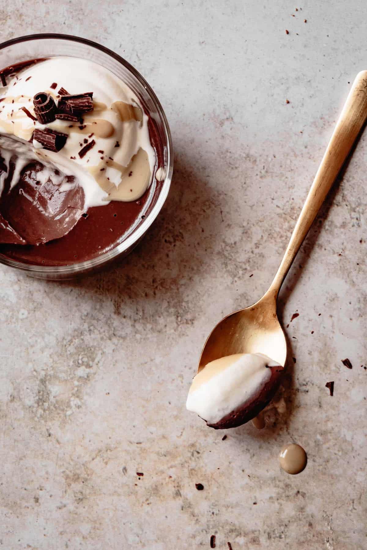 paleo pudding recipe in a glass, overhead, with a spoonful taken out