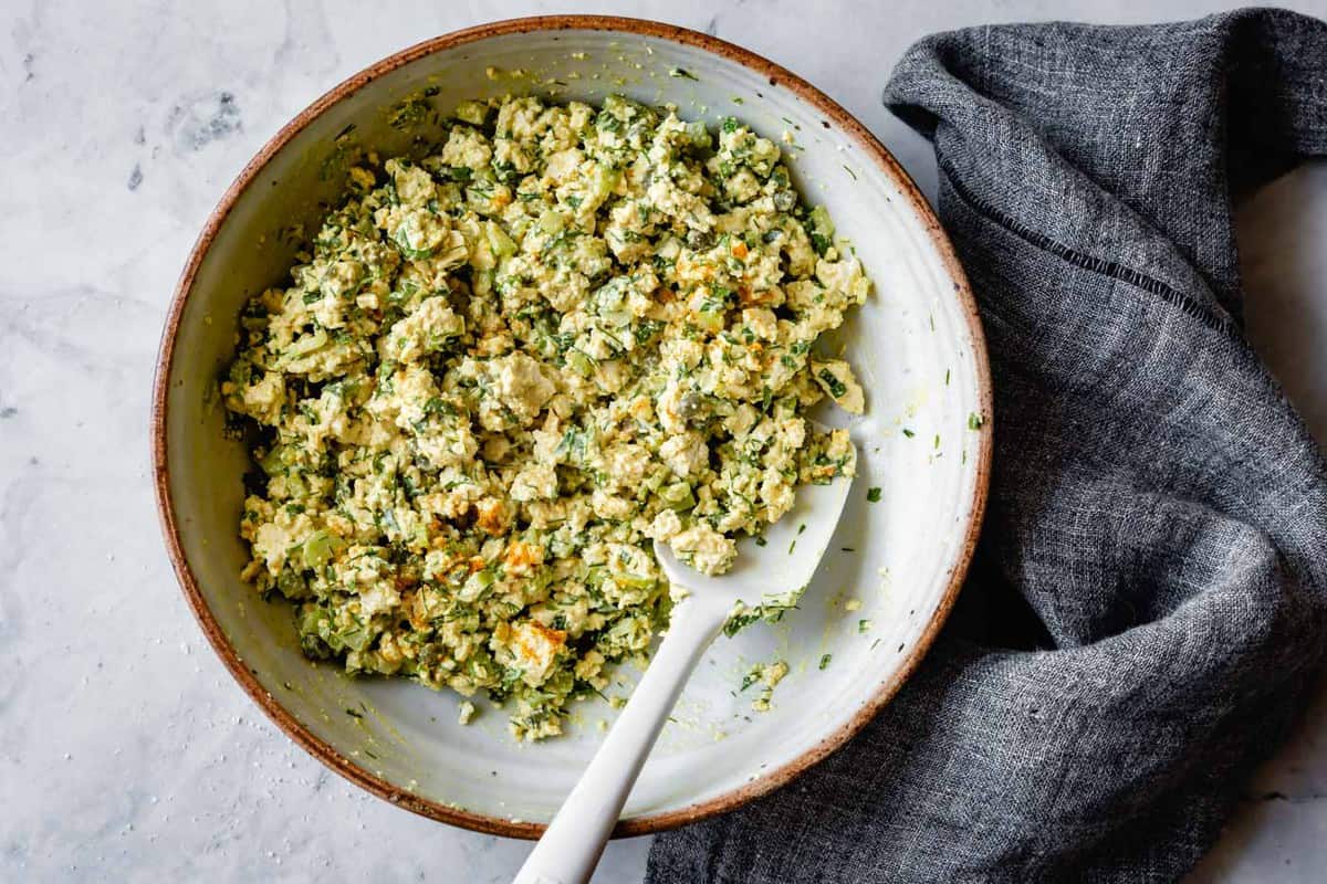 mixing tofu egg salad in a bowl