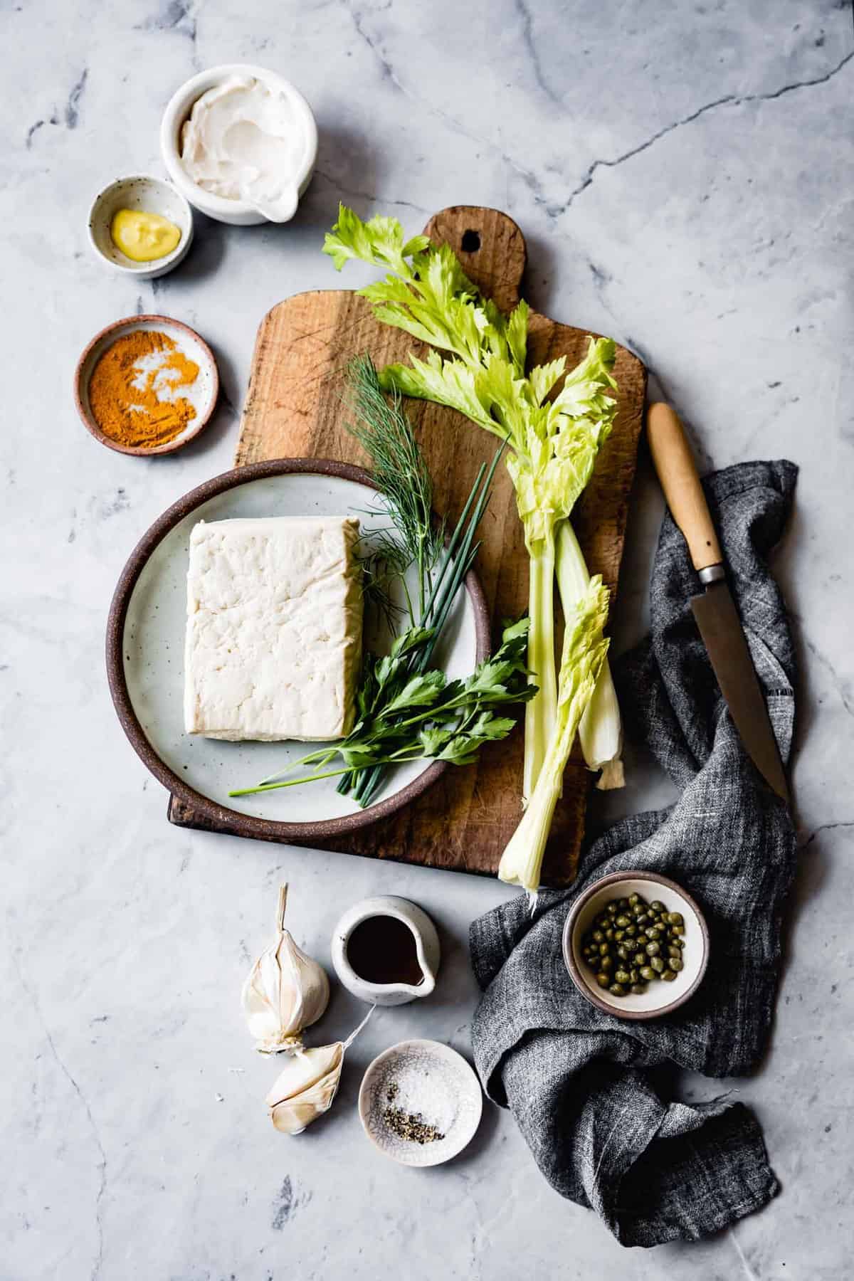 curried tofu salad ingredients on blue marble surface