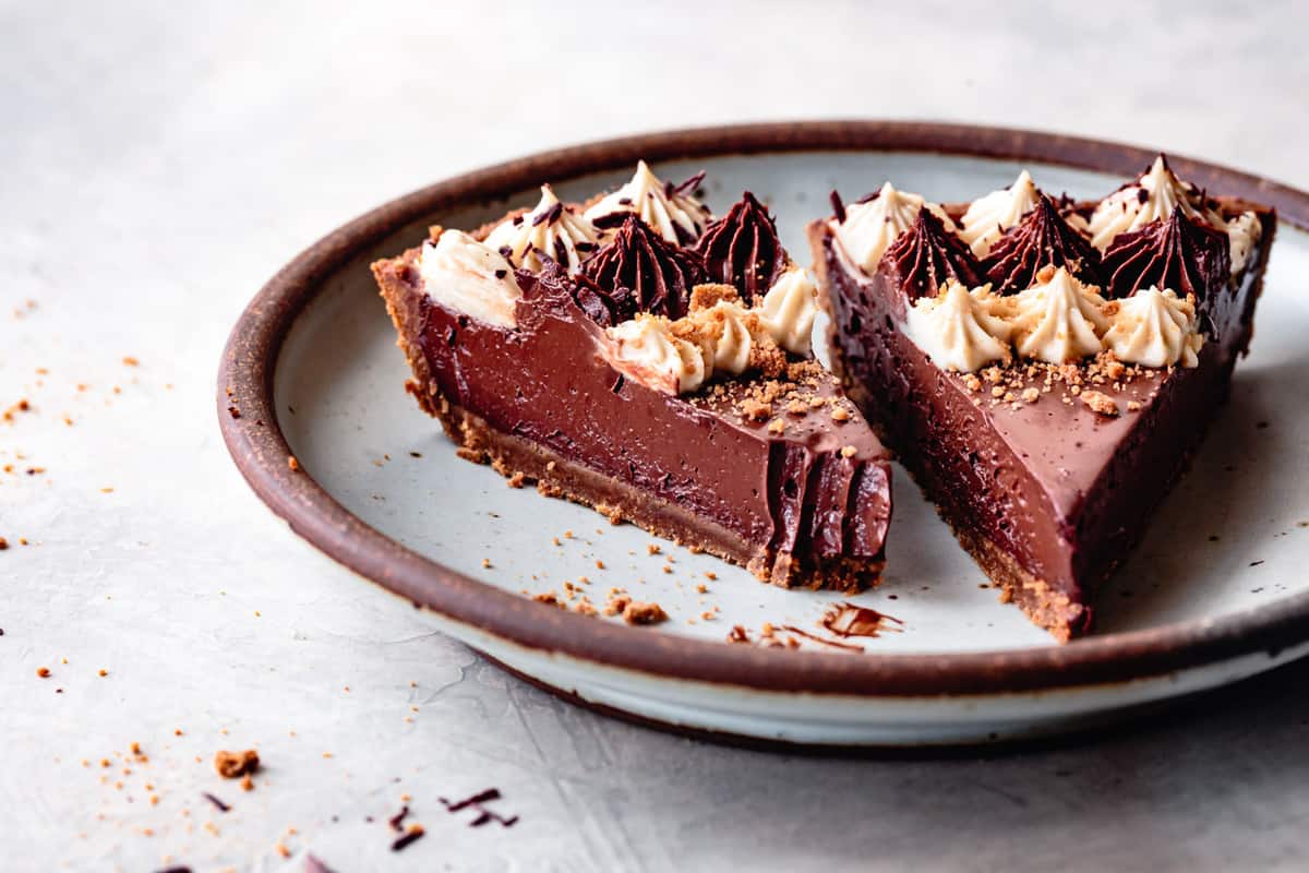 two slices of gluten-free chocolate pie on a blue plate, low angle