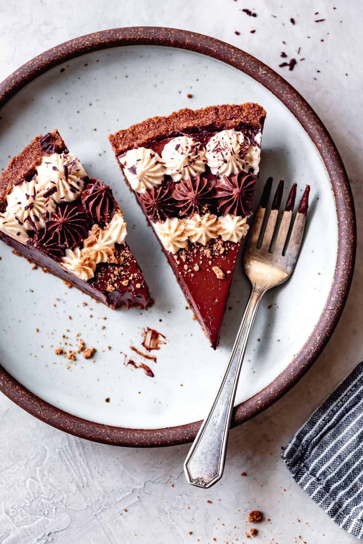 two slices of gluten-free vegan chocolate cream pie on a light blue plate with a fork