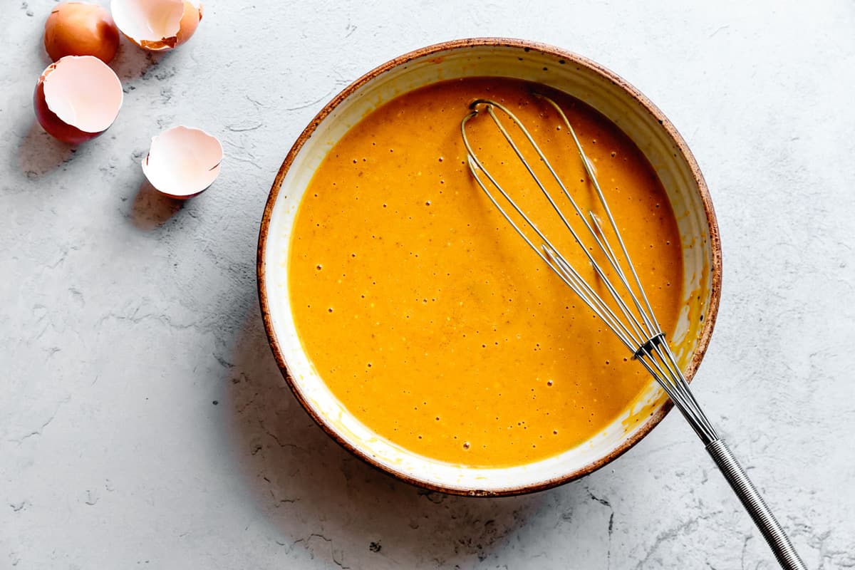 wet ingredients for vegan gluten-free pumpkin muffins whisked in a bowl