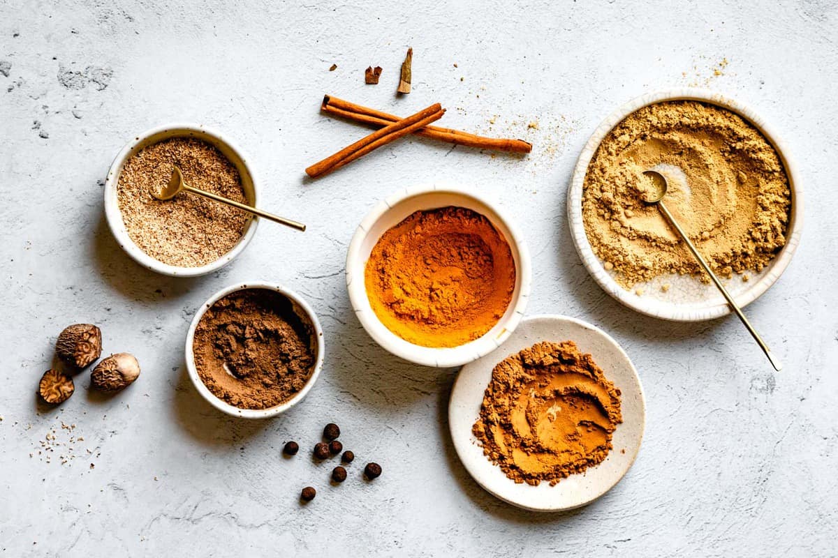 horizontal image of ground pumpkin pie spices in bowls