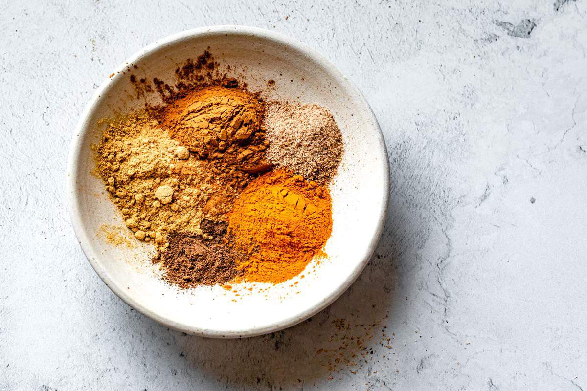 how to make homemade pumpkin spice - individual pumpkin pie spices in a white bowl