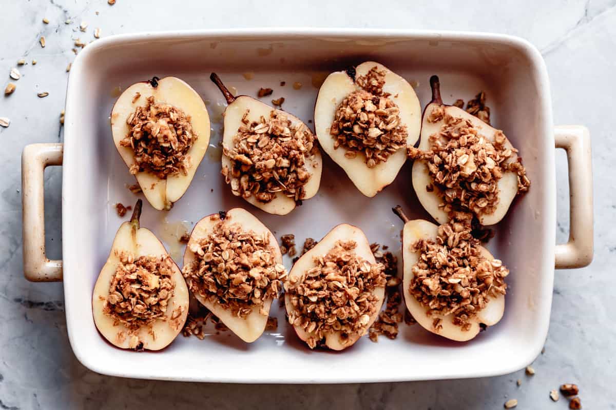 unbaked stuffed pears in a roasting pan