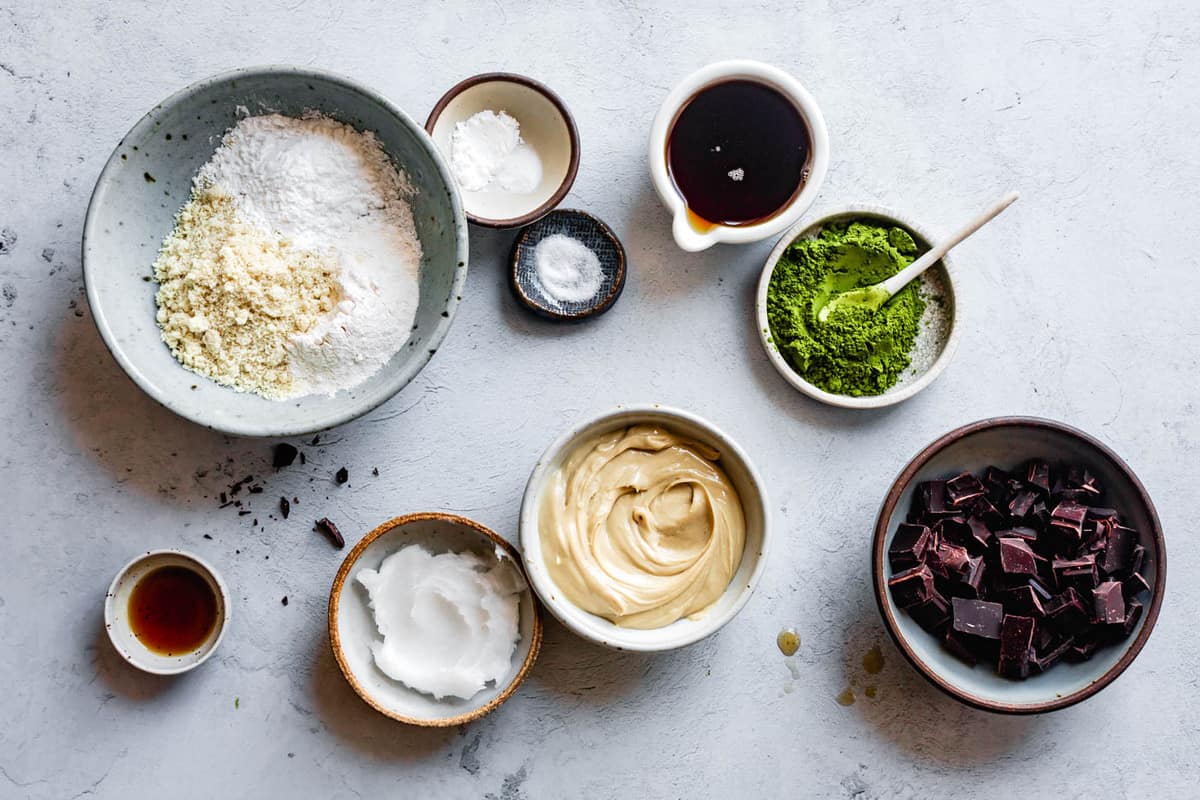 ingredients for matcha chocolate chip cookies recipe on a gray stone surface