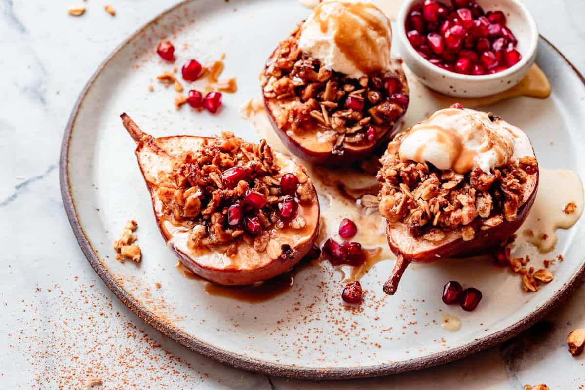 baked pears with toppings on a plate, wide shot