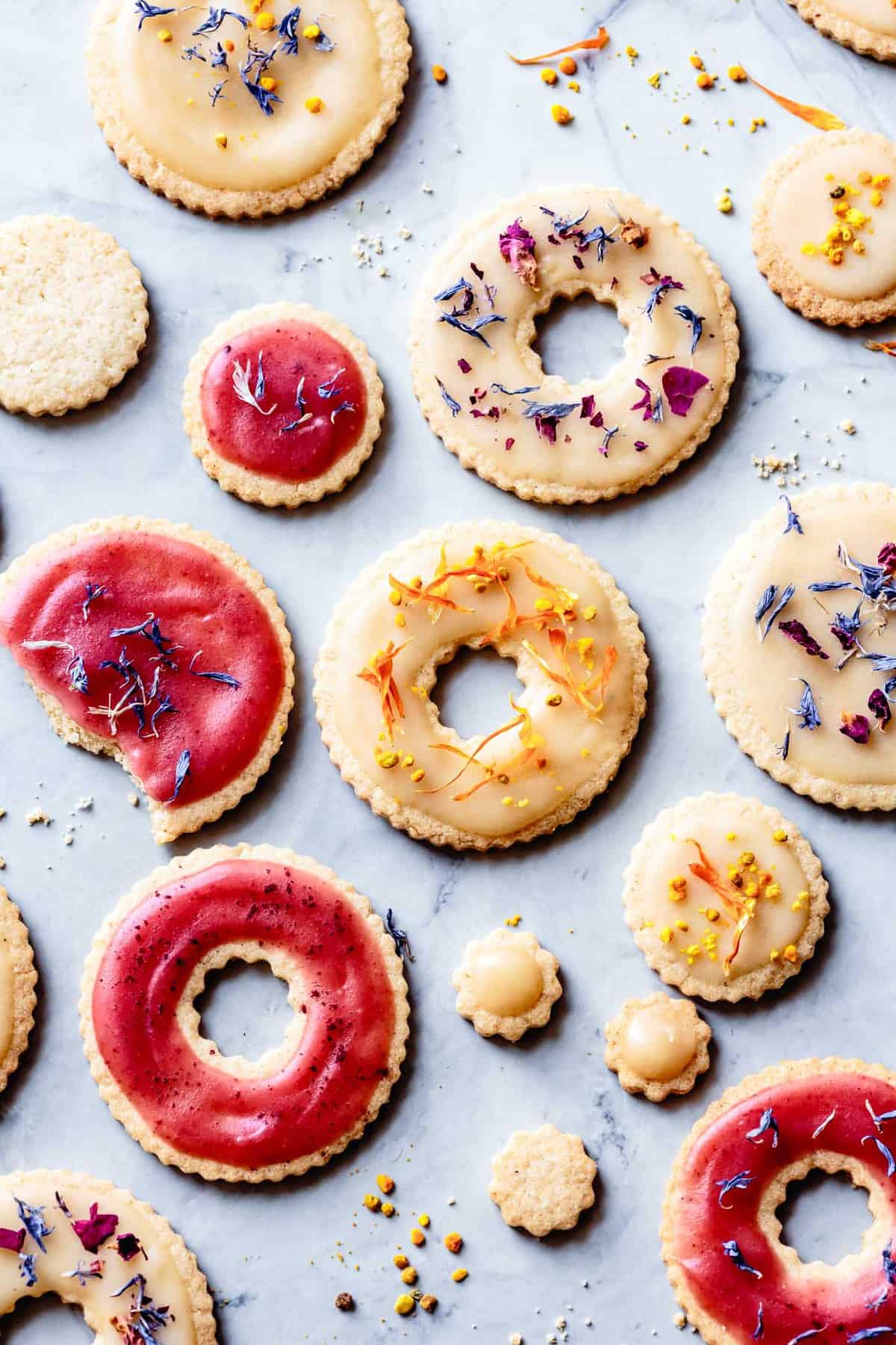 overhead shot of gluten-free sugar cookies with pretty natural decorations on marble