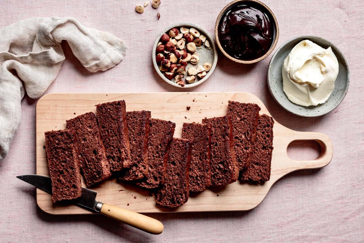 slices of gluten-free chocolate sponge cake on a board