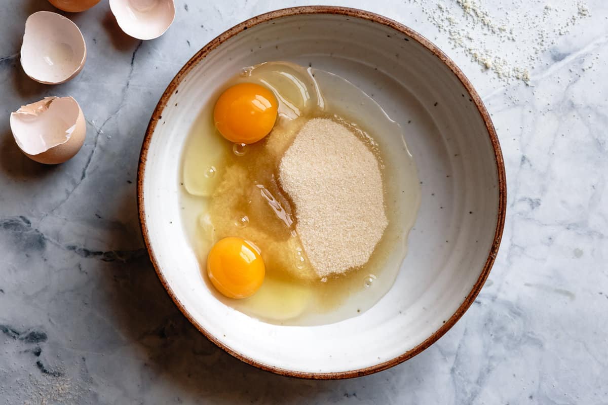 sugar and eggs in a stoneware bowl