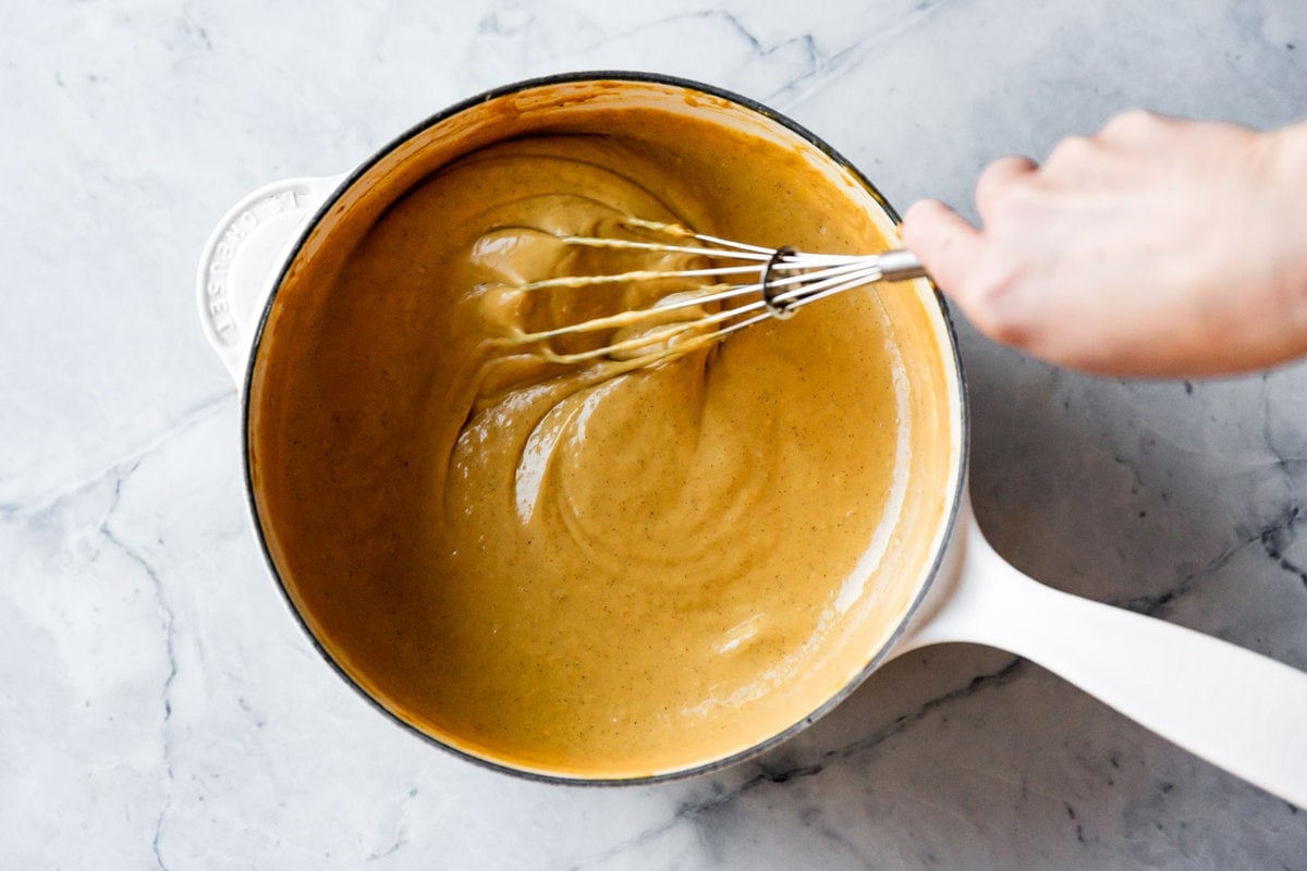 whisking the pudding to show texture