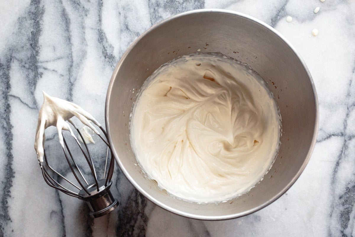 the mascarpone has been whipped, shown in the mixer bowl with the whisk 