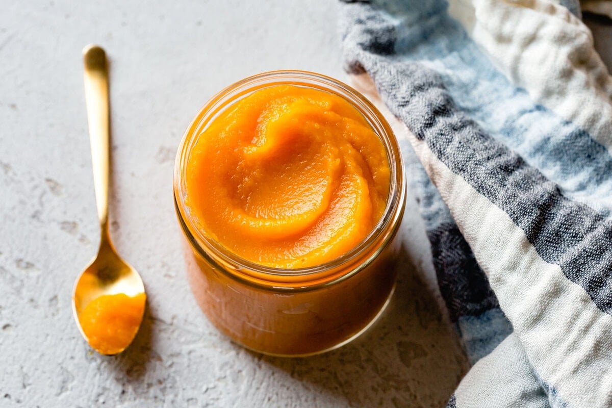 a jar of homemade pumpkin puree swirled