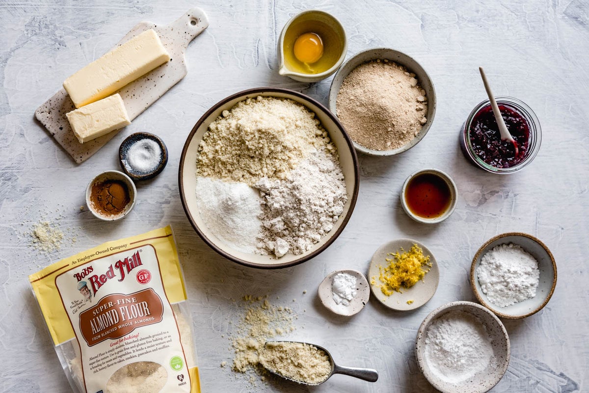 ingredients have been arranged prettily in ceramic bowls including a bag of almond flour