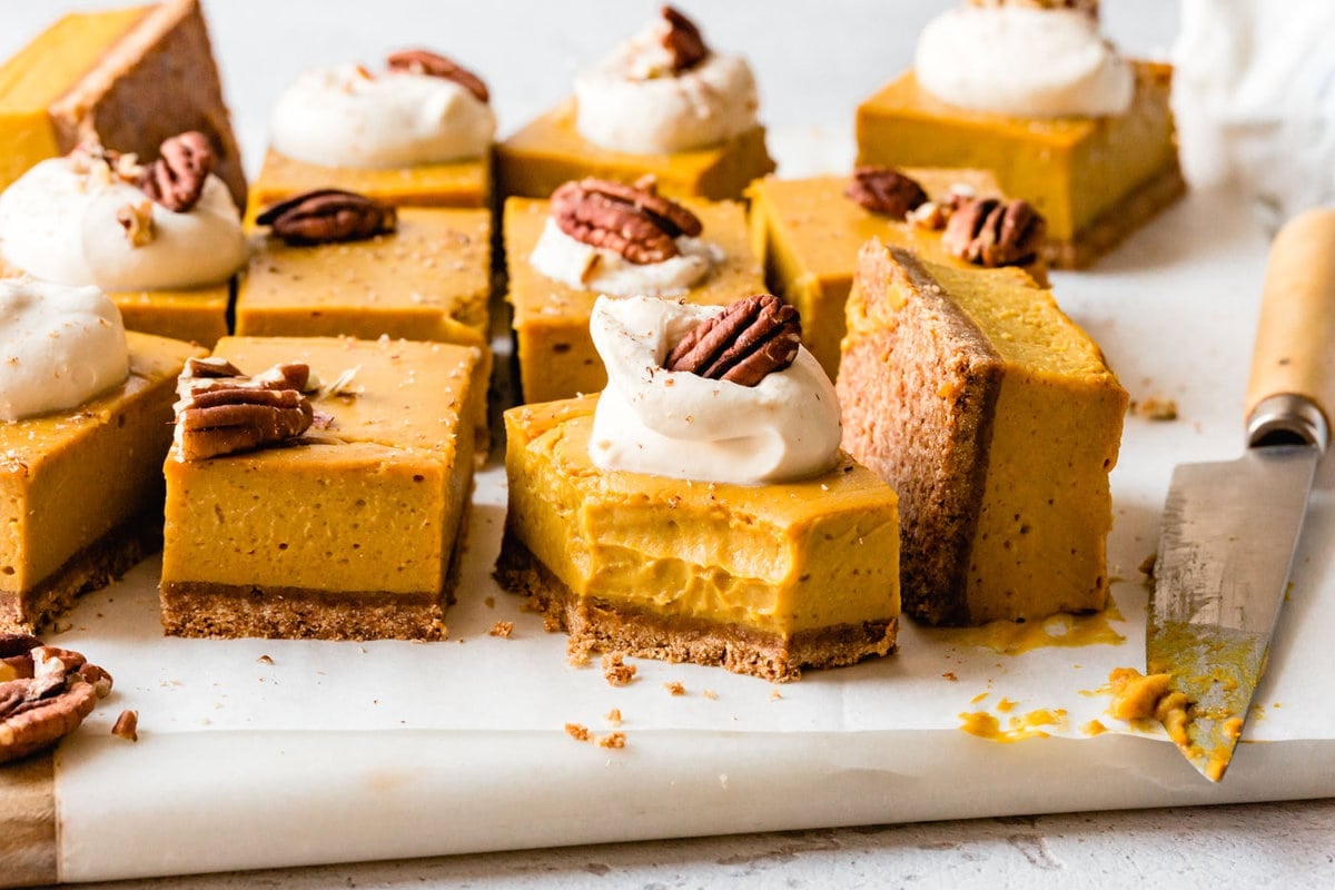 gooey vegan pumpkin bars shown from the side to reveal layers of crust and filling