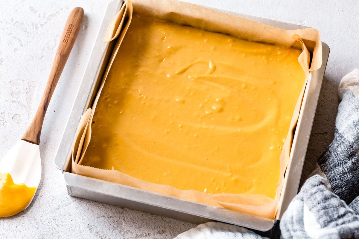 creamy pumpkin filling has been swirled in the pan over the crust