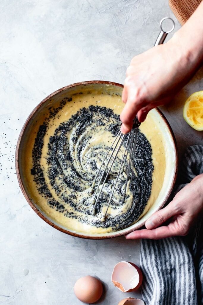 poppyseeds are being whisked into the batter with a sexy swirl