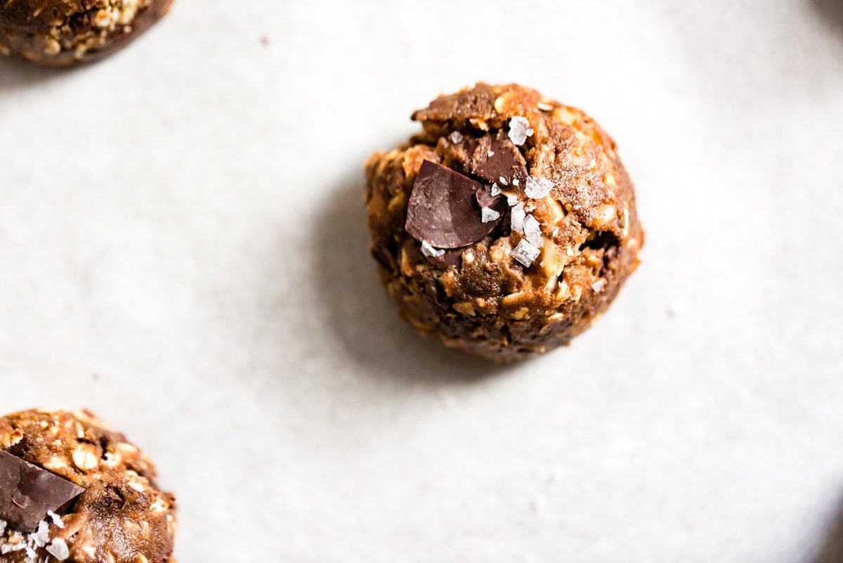 a close-up view of a scooped cookie ready to bake