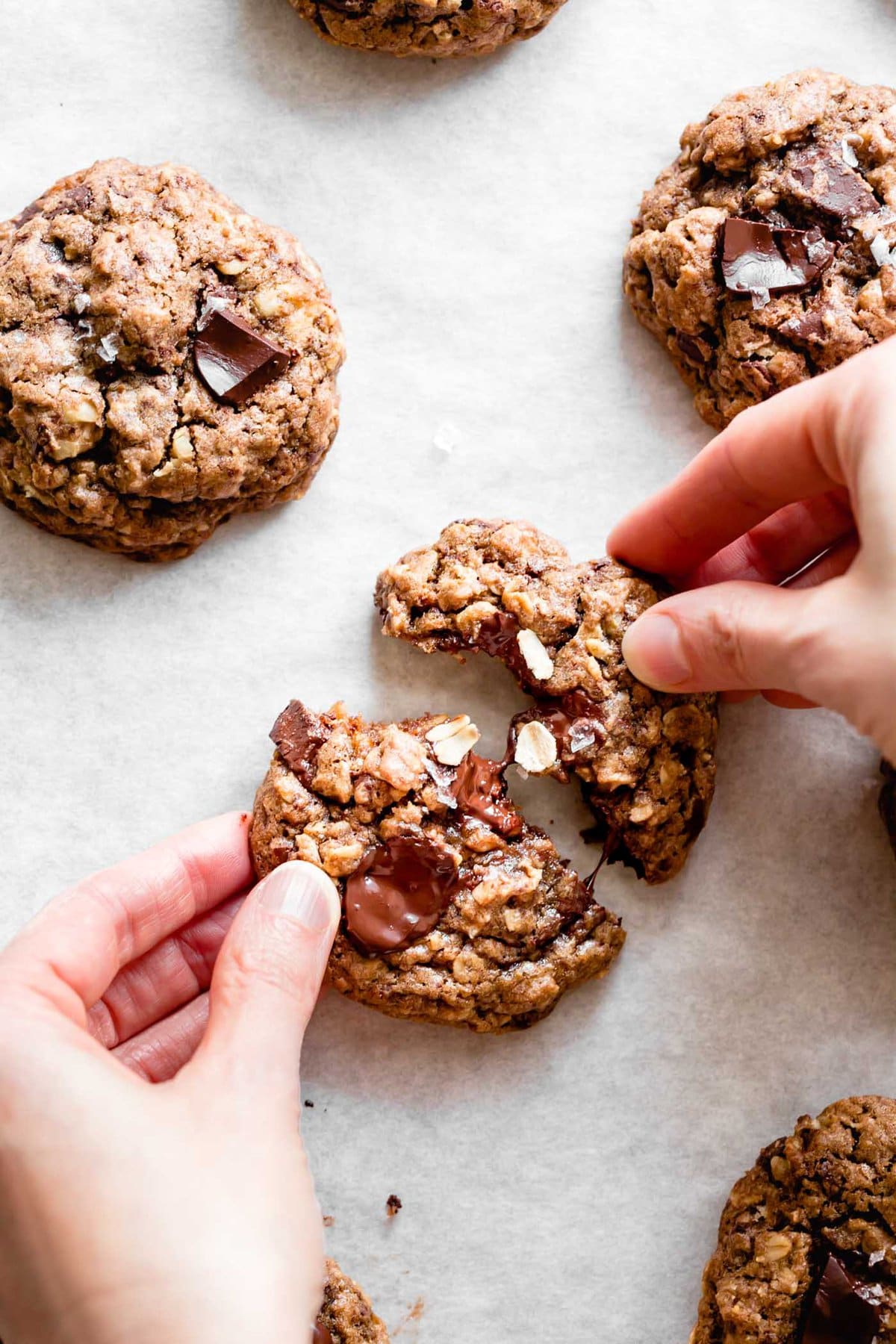 hands are tearing a cookie in half