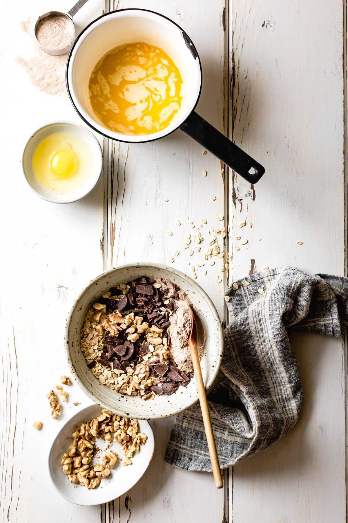 Teff cookie ingredients are arranged prettily on a rustic white-washed wooden surface