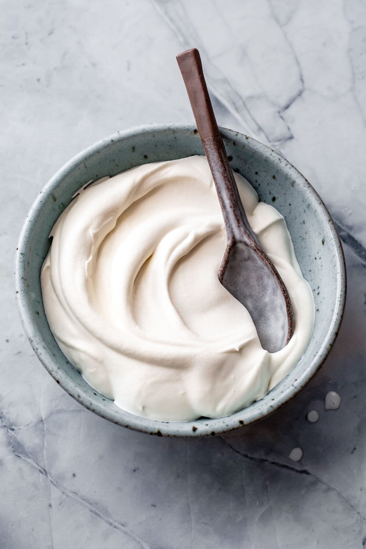 A blue speckled bowl holds swirls of silky whipped creme fraiche.