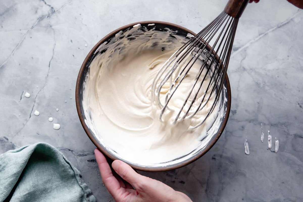 hands are whipping the creme fraiche cream
