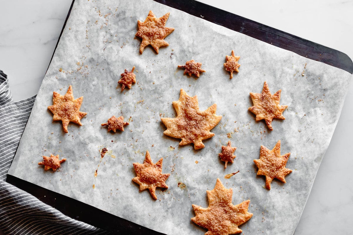 leaf cutouts are on a baking sheet