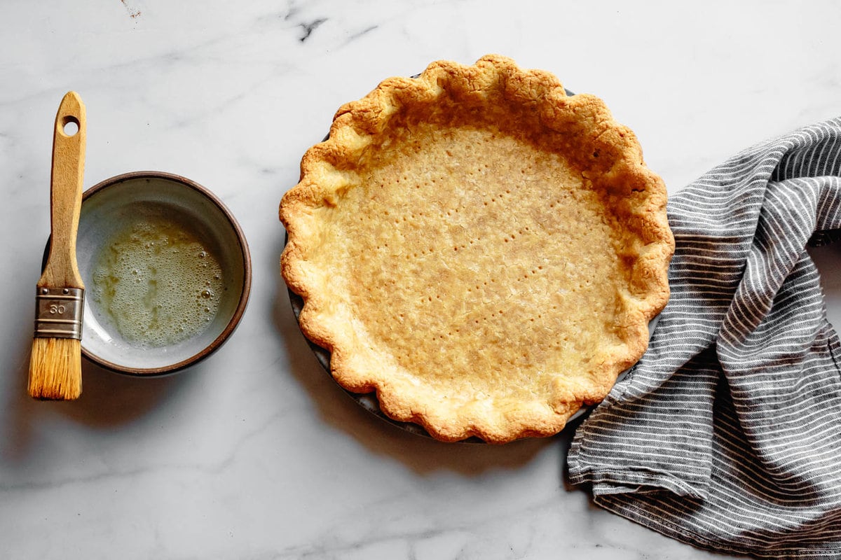 parbaked gluten-free pie crust has been brushed with egg white