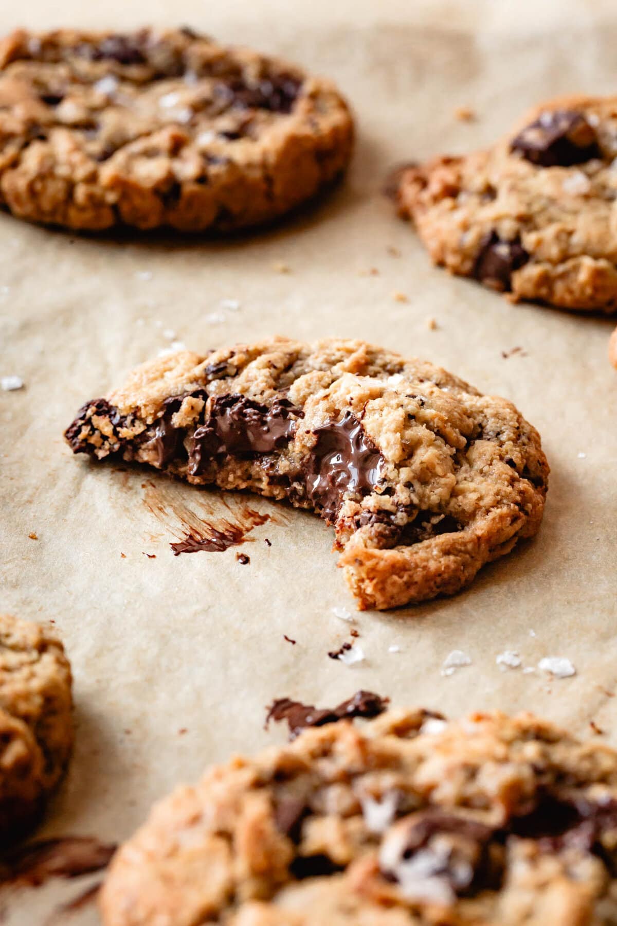 a cookie with a big bite taken out reveals melty chocolate oozing out