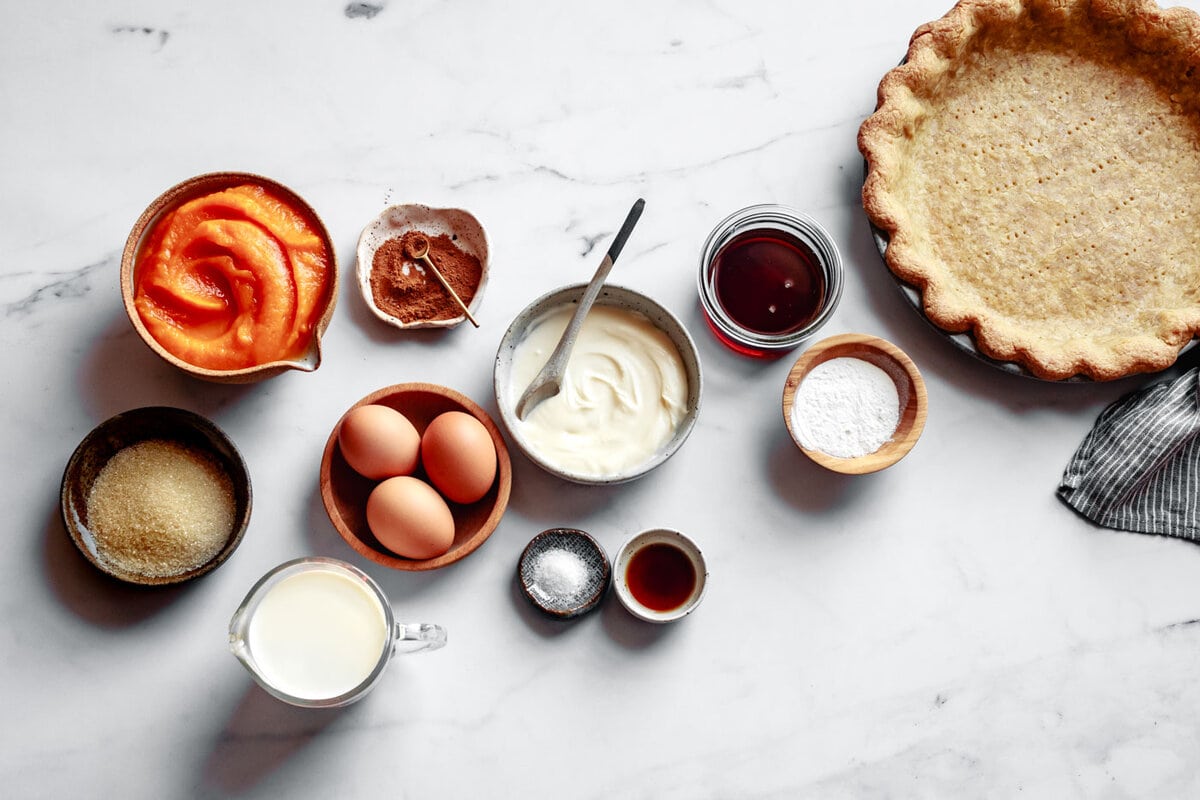 paleo pie ingredients have been arranged on a marble surface