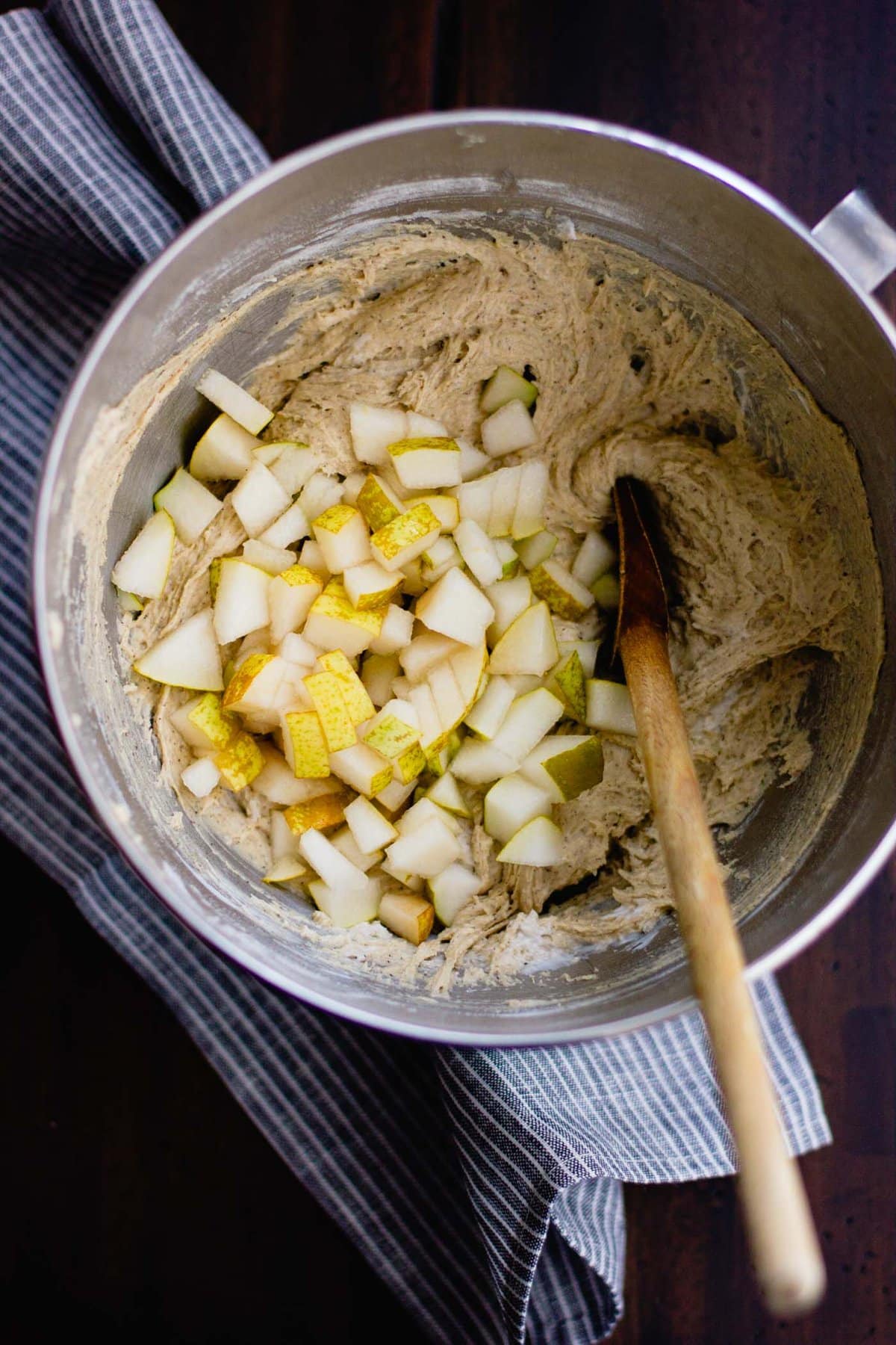pear chunks have been added to the bowl of batter
