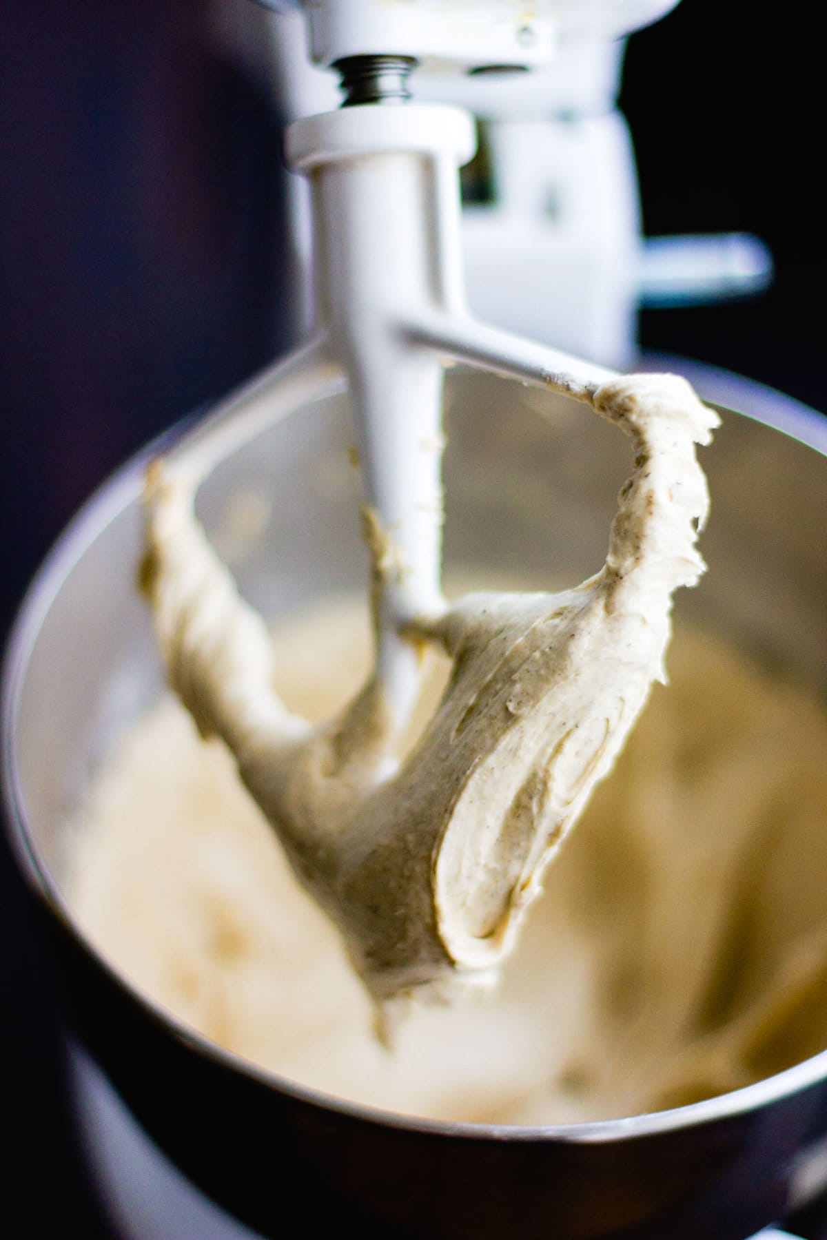 the batter has been mixed in a stand mixer and is shown on the paddle looking buttery and inviting