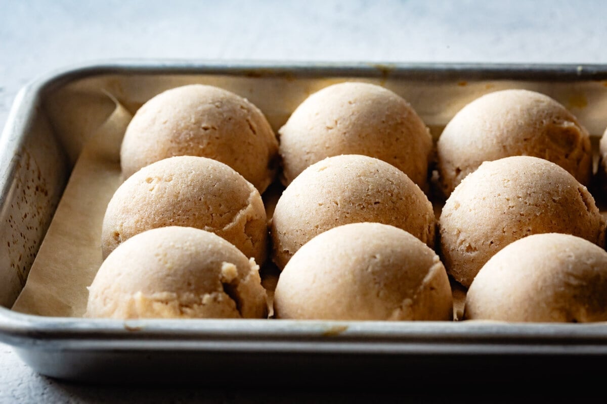 dough balls are on a baking sheet