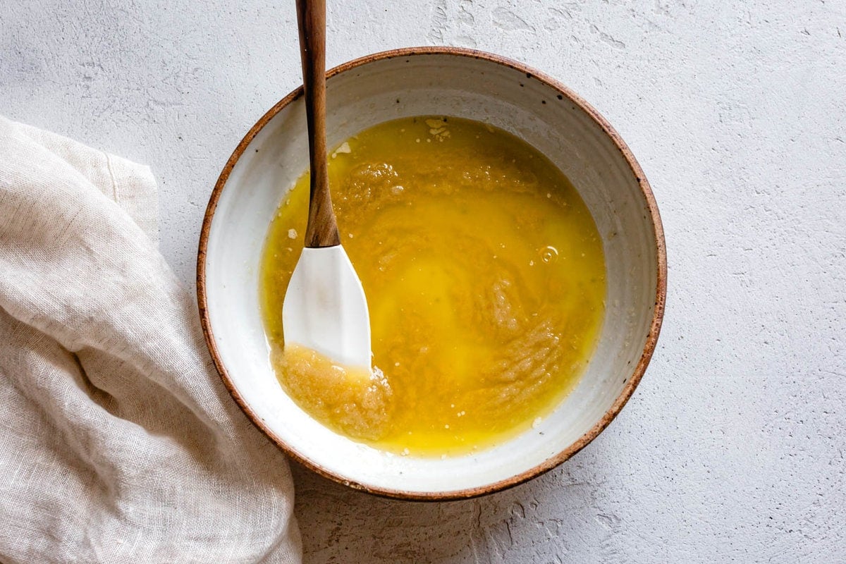 melted butter and sugar are in a bowl