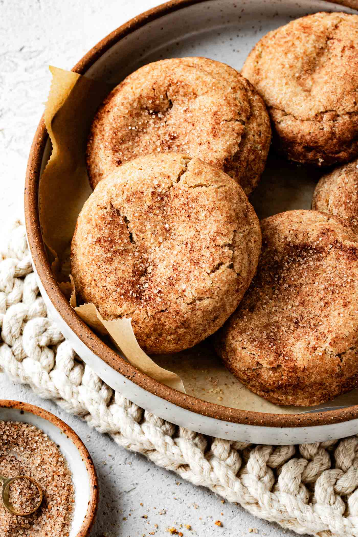 a plate is stacked with cinnamon-kissed snickerdoodles for a cozy scene