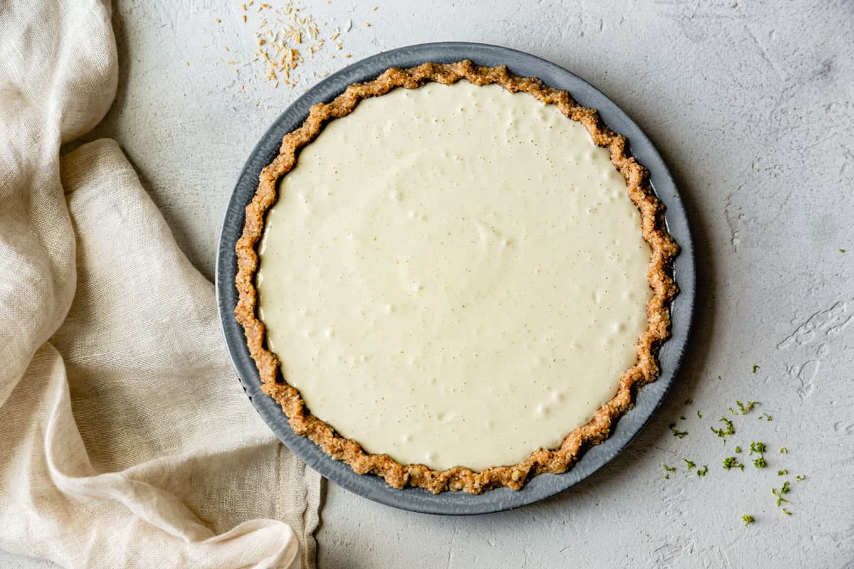 healthy key lime pie filling poured into crust