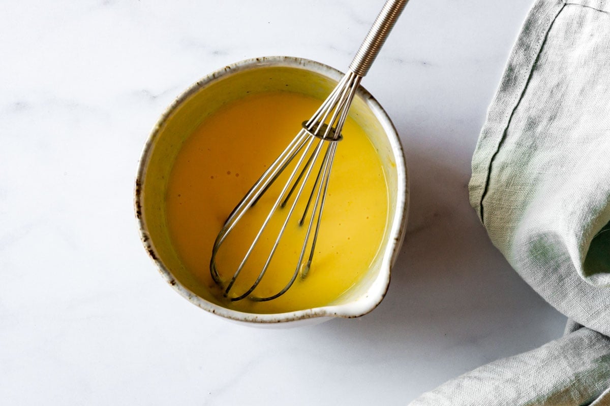 egg and buttermilk have been whisked in a bowl