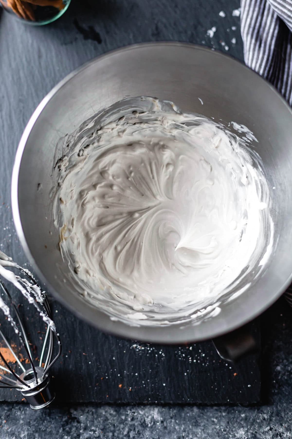 coconut cream has been whipped in the bowl of a stand mixer