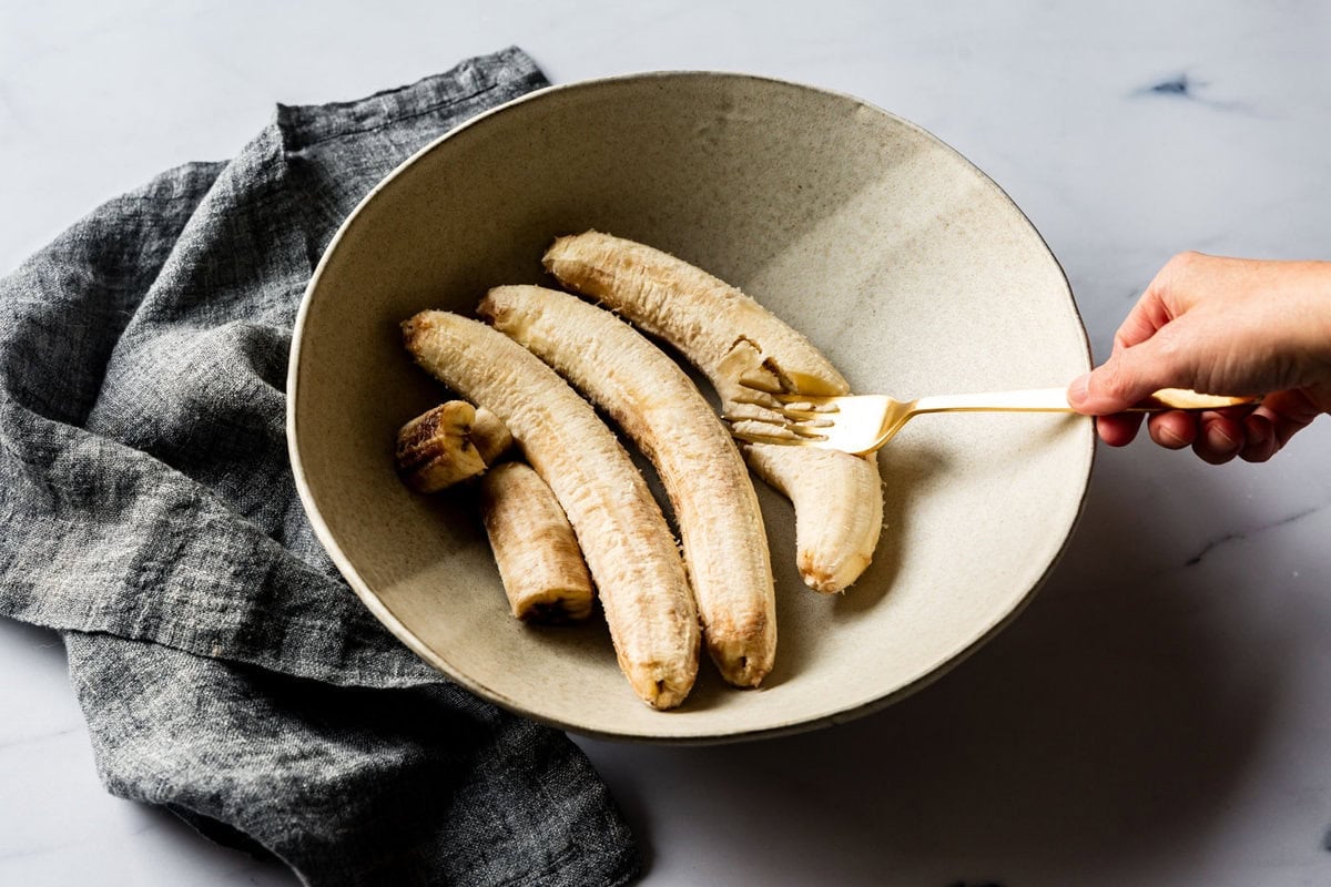 mashing bananas in a bowl