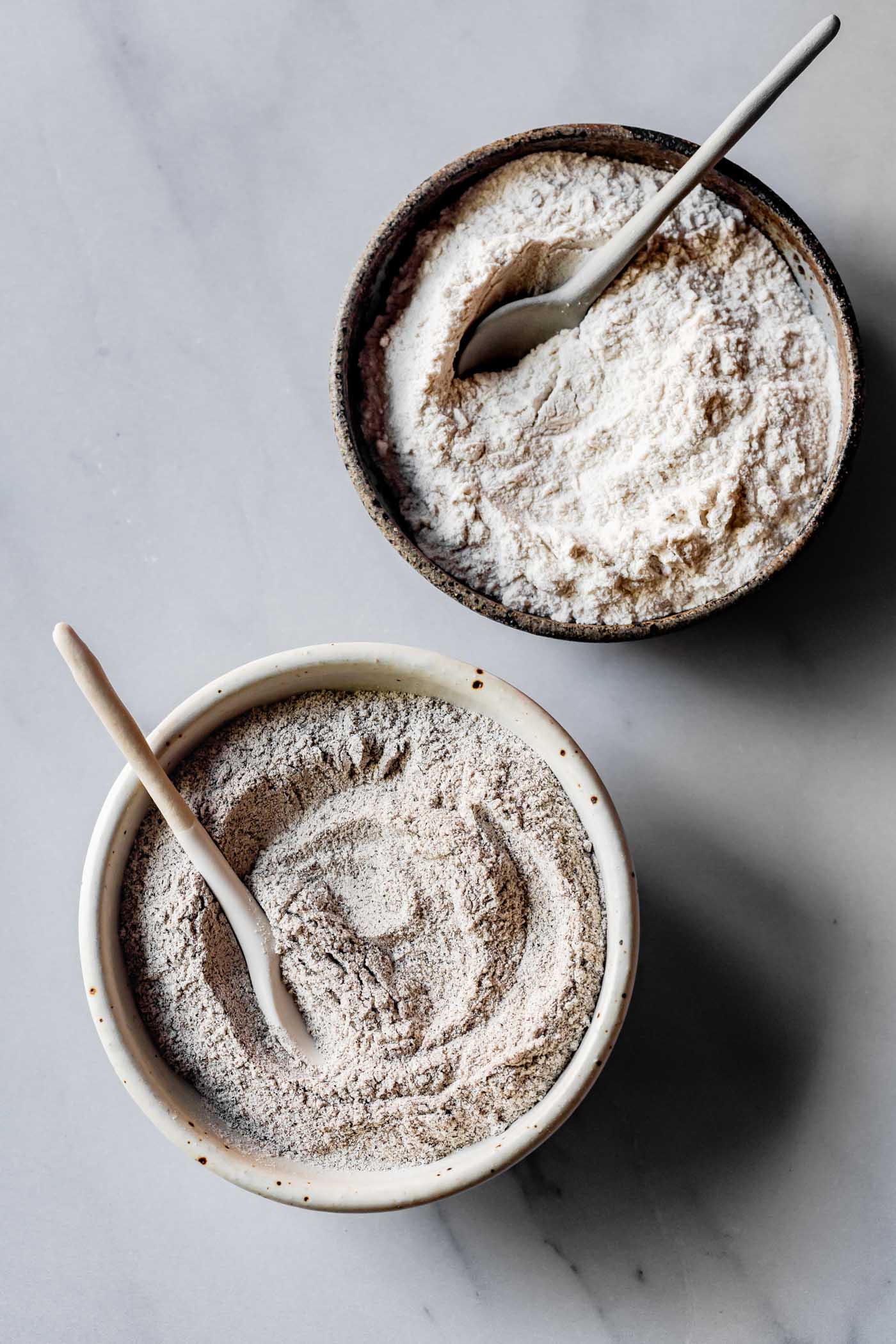 dark and light buckwheat flours in bowls
