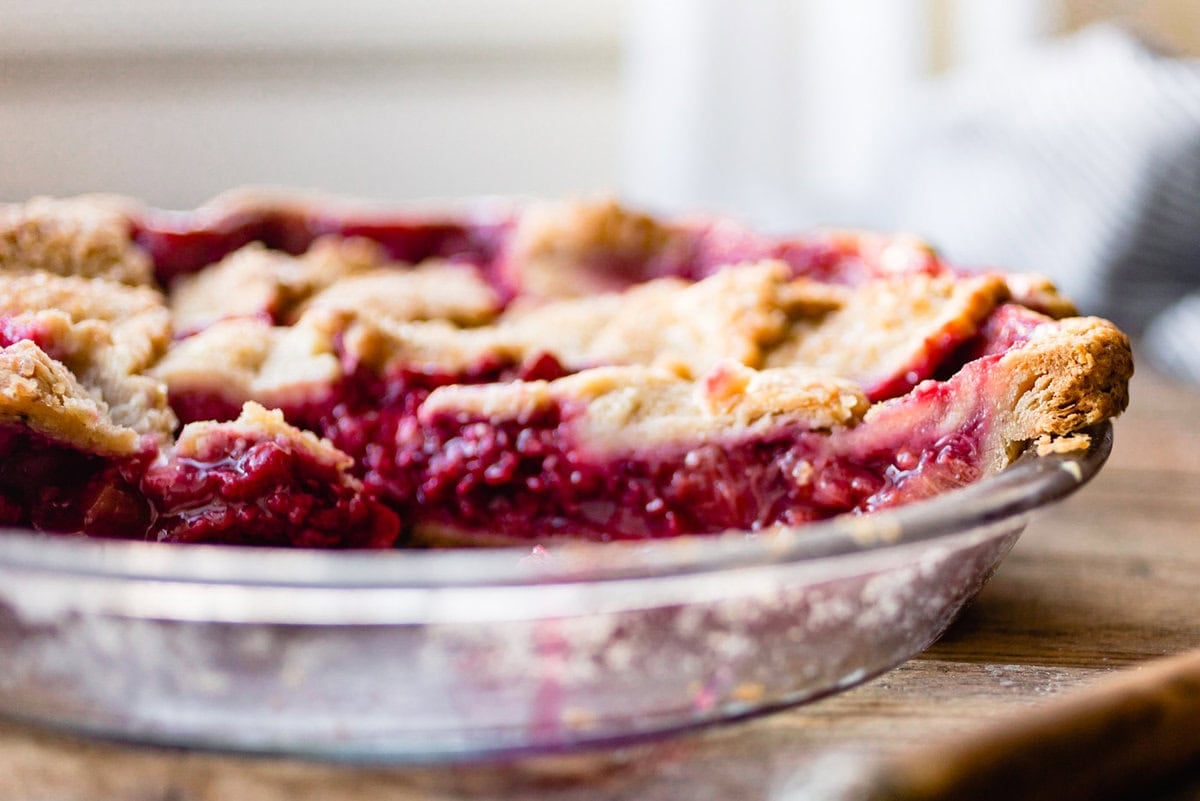 pie shown from the side showing off flaky layers and jammy filling